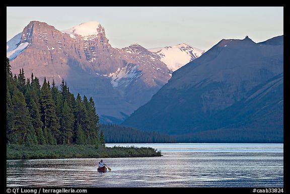 Canoist paddling on Maligne Lake at sunset. Jasper National Park, Canadian Rockies, Alberta, Canada (color)