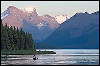 Canoist paddling on Maligne Lake at sunset. Jasper National Park, Canadian Rockies, Alberta, Canada