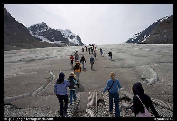 Tourists walking onto  Athabasca Glacier. Jasper National Park, Canadian Rockies, Alberta, Canada (color)