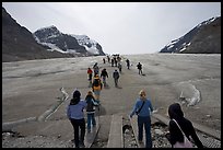 Tourists walking onto  Athabasca Glacier. Jasper National Park, Canadian Rockies, Alberta, Canada