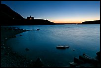 Boulders in Waterton Lake and Prince of Wales hotel, dawn. Waterton Lakes National Park, Alberta, Canada ( color)