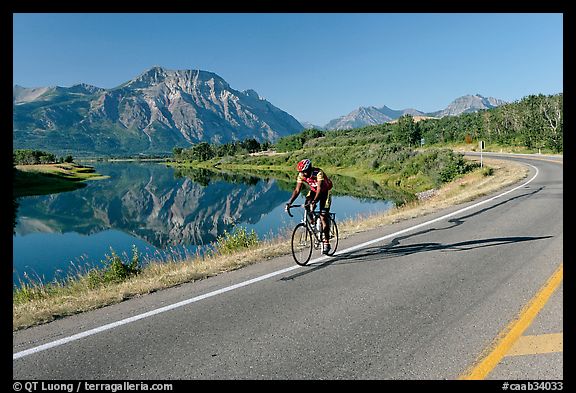 Cyclist next to Lower Waterton Lake. Waterton Lakes National Park, Alberta, Canada