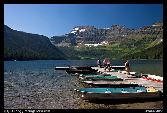 Dock and small boats, with tourists walking down, Cameron Lake. Waterton Lakes National Park, Alberta, Canada (color)