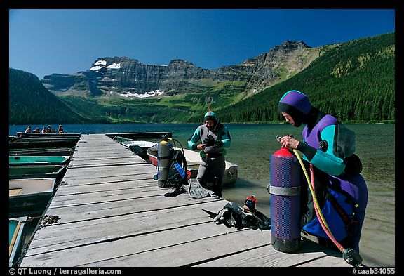 Scuba divers getting ready to dive, Cameron Lake. Waterton Lakes National Park, Alberta, Canada