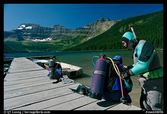 Scuba divers preparing to dive into cold waters of Cameron Lake. Waterton Lakes National Park, Alberta, Canada (color)