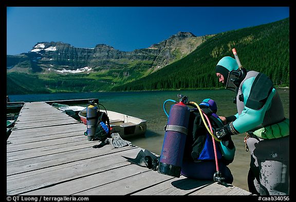 Scuba divers preparing to dive into cold waters of Cameron Lake. Waterton Lakes National Park, Alberta, Canada