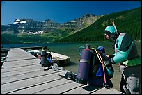 Scuba divers preparing to dive into cold waters of Cameron Lake. Waterton Lakes National Park, Alberta, Canada