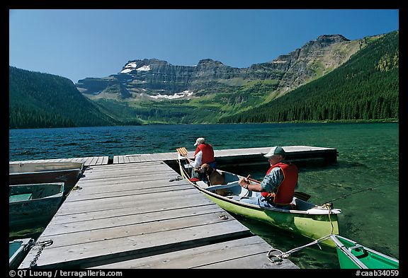 Canoists parking to dock, Cameron Lake. Waterton Lakes National Park, Alberta, Canada (color)