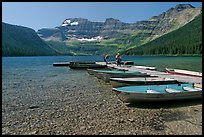 Fishermen walking on dock after unloading a canoe, Cameron Lake. Waterton Lakes National Park, Alberta, Canada ( color)