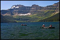 Canoists on Cameron Lake. Waterton Lakes National Park, Alberta, Canada