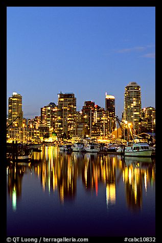 Fishing boats and skyline light reflected at night. Vancouver, British Columbia, Canada (color)