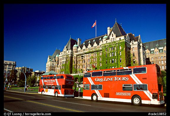 Red double-decker tour busses in front of Empress hotel. Victoria, British Columbia, Canada