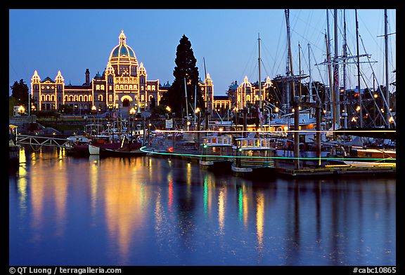 Boats in inner harbor with a trail of lights and parliament building lights. Victoria, British Columbia, Canada (color)