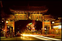 Chinatown gate with trail of lights at night. Victoria, British Columbia, Canada