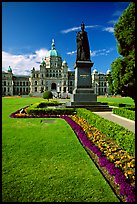 Lawn, statue of Queen Victoria for whom the city was named, and parliament. Victoria, British Columbia, Canada