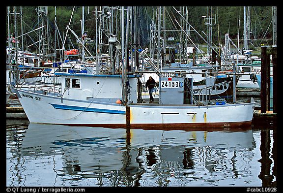 Fishing boat and reflections in harbor, Uclulet. Vancouver Island, British Columbia, Canada (color)