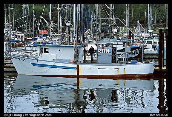 Fishing boat and reflections in harbor, Uclulet. Vancouver Island, British Columbia, Canada