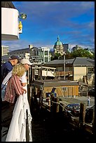 Passengers standing on the deck of the ferry, as it sails into the Inner Harbor. Victoria, British Columbia, Canada (color)