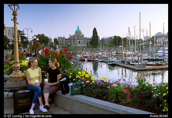 Young Women sitting, Inner harbor. Victoria, British Columbia, Canada (color)