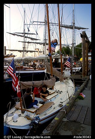 Kids in a small sailboat docked in Inner Habor. Victoria, British Columbia, Canada