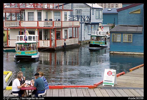 Harbor ferries and outdoor eatery, Upper Harbor. Victoria, British Columbia, Canada (color)