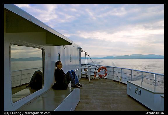 Passenger sitting on the deck of ferry. Vancouver Island, British Columbia, Canada