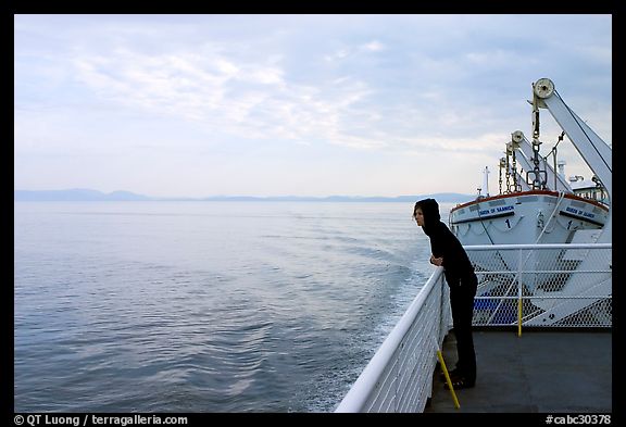 Woman looking out from deck of ferry. Vancouver Island, British Columbia, Canada (color)