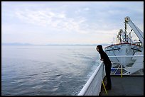 Woman looking out from deck of ferry. Vancouver Island, British Columbia, Canada (color)