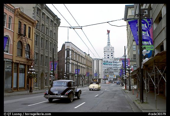 Street in Gastown with two old cars. Vancouver, British Columbia, Canada