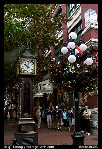 Tourists watch steam clock in Water Street. Vancouver, British Columbia, Canada