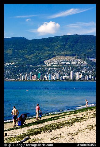 Family near the water on a beach, Stanley Park. Vancouver, British Columbia, Canada (color)