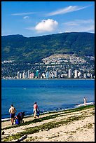 Family near the water on a beach, Stanley Park. Vancouver, British Columbia, Canada