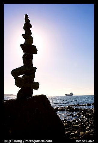 Backlit balanced rocks and ship in the distance. Vancouver, British Columbia, Canada (color)