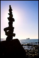 Backlit balanced rocks and ship in the distance. Vancouver, British Columbia, Canada