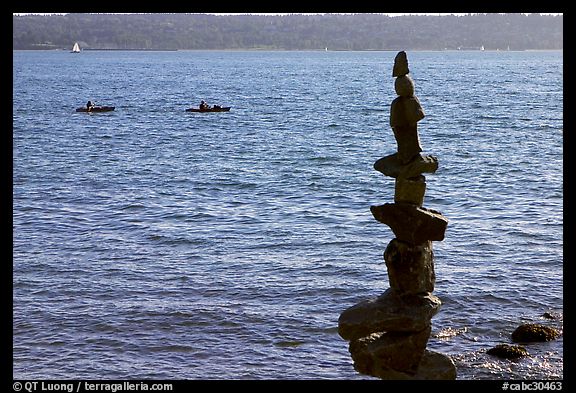 Balanced rocks and kayaks in a distance. Vancouver, British Columbia, Canada (color)