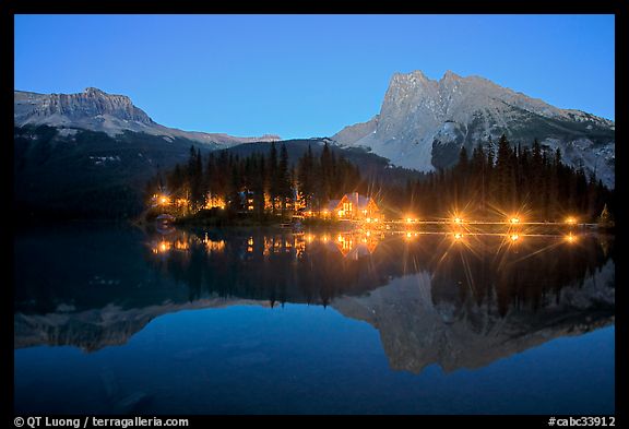 Lighted cabins and mountains reflected in Emerald Lake at night. Yoho National Park, Canadian Rockies, British Columbia, Canada