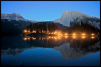 Lighted cabins and mountains reflected in Emerald Lake at night. Yoho National Park, Canadian Rockies, British Columbia, Canada (color)