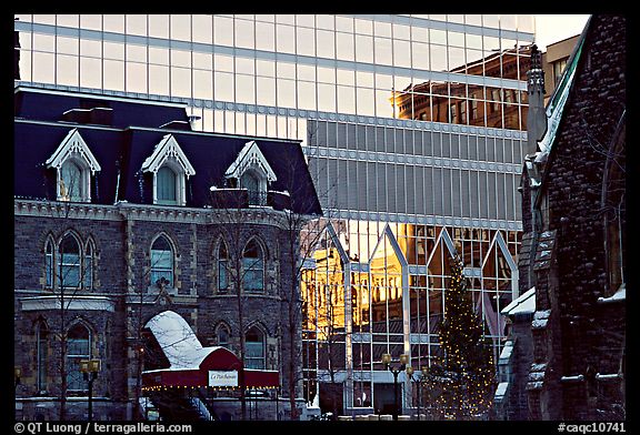 Reflection of an older building in the glass of a modern building, Montreal. Quebec, Canada (color)