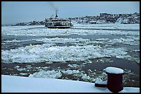 Ferry crossing the Saint Laurent river partly covered with ice, Quebec City. Quebec, Canada