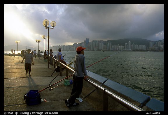 Fishing on the waterfront promenade, sunrise. Hong-Kong, China (color)