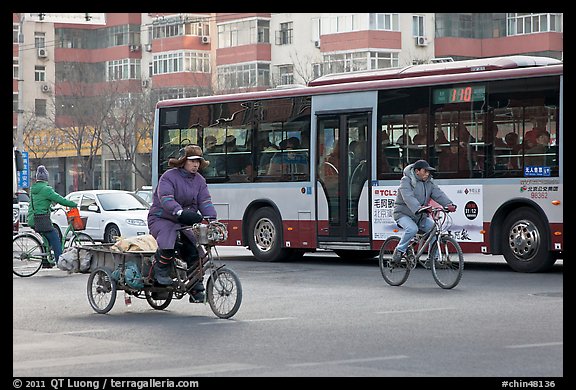 Tricyle, bicycles and bus on street. Beijing, China (color)