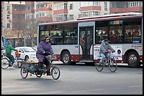 Tricyle, bicycles and bus on street. Beijing, China