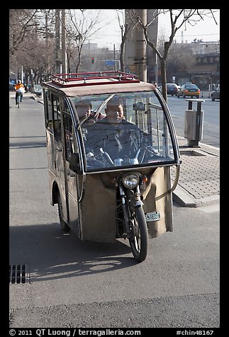 Enclosed three wheel motorcycle on street. Beijing, China