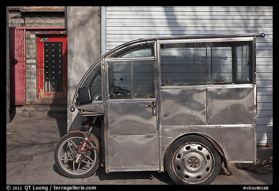 Enclosed scooter on sidewalk. Beijing, China (color)