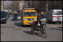 Tricycle and taxi on street. Beijing, China