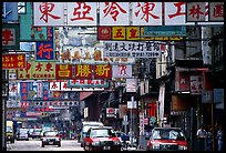 Taxicabs in a street filled up with signs in Chinese, Kowloon. Hong-Kong, China ( color)