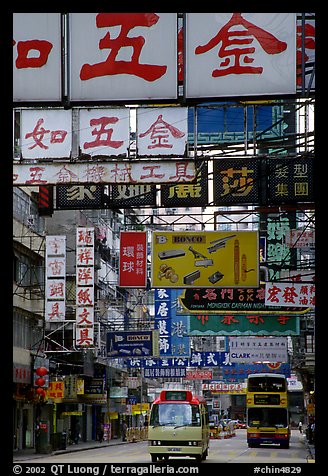 Busses in a street filled up with signs in Chinese, Kowloon. Hong-Kong, China (color)