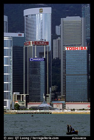 Small boat with a backdrop of skycrapers of Hong-Kong Island. Hong-Kong, China (color)