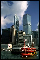 Ferry leaves a pier on Hong-Kong Island. Its symmetrical shape alleviates the need for turning around. Hong-Kong, China