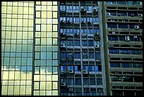 Glass building next to older buildings with air conditioners, Hong-Kong Island. Hong-Kong, China ( color)